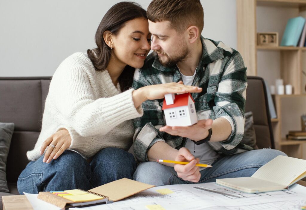 medium-shot-couple-holding-small-house.jpg